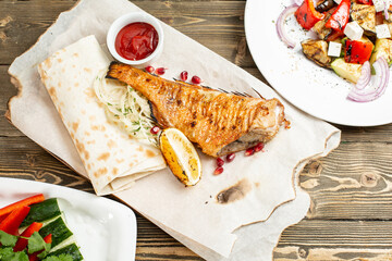 sea bass grill. Serving on a wooden Board on a rustic table. Barbecue restaurant menu, a series of...