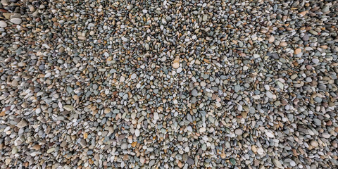 panorama view from above on surface of small pebbles on the sea coast