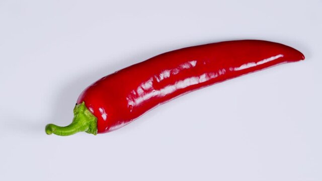 Hot red chili pepper on a white background. Harvest of red pepper.