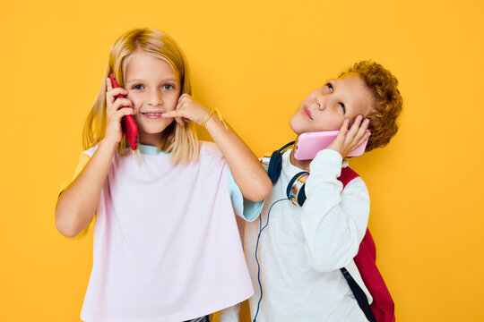 Two Kids Boy And Girl With School Backpacks Phone Entertainment