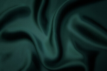 Texture, background, pattern. Texture of green silk fabric. Beautiful emerald green soft silk...