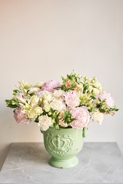 Beautiful flower arrangement in a green ceramic vase. Flowers bunch, set for interior. Fresh cut flowers for decoration home. European floral shop. Delivery fresh cut flower.v