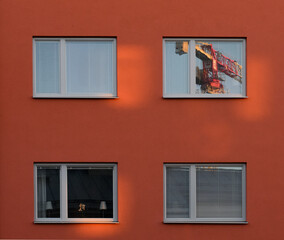 Windows with building crane mirroring.