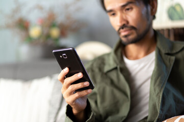 Obraz na płótnie Canvas Lifestyle man using smartphone at home, connection, communication, application concept