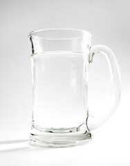 glass of drinking water, studio background with lights and shadows. concept of purity, drinking water, healthy lifestyle or medical. 