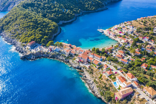 Assos picturesque fishing village from above, Kefalonia, Greece. Aerial drone view. Sailing boats moored in turquoise bay © Igor Tichonow