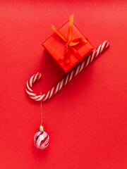 Toy, red watch, gift, lollipop, candy on a red background.