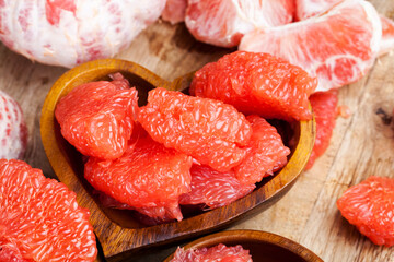 peeled red grapefruit divided into slices