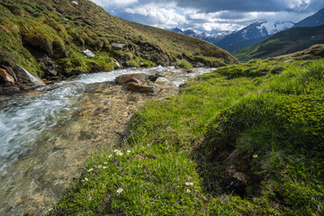 Fototapeta na wymiar Mountain river on the pass - Grossglockner, Austria