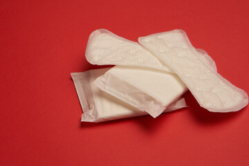 pads tampons underwear feminine hygiene red background