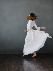 Fototapeta na wymiar Woman in white dress movement dance glamor