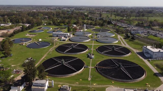 Orbit shot taken of Aysa water purification plant, one of the largest in Buenos Aires, Argentina with highway running on the left side of the plant.