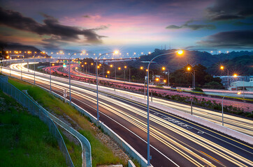 Fototapeta na wymiar Light trails on motorway highway at night, long exposure abstract urban background