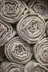 stack of beige wool blankets in store. autumn - winter concept of home warmth and comfort. textile shop background