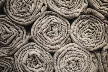 stack of beige wool blankets in store. autumn - winter concept of home warmth and comfort. textile shop background