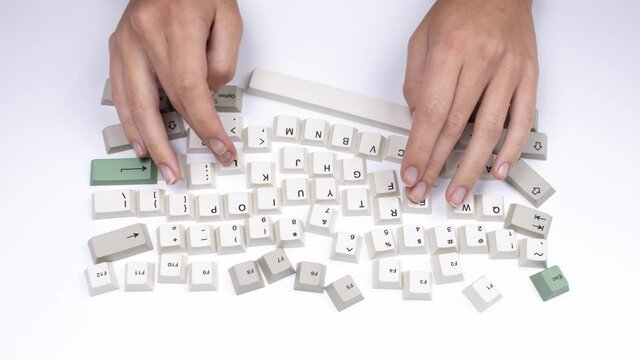 loose keyboard keys with hands typing