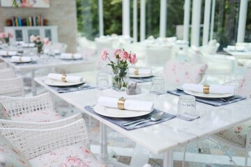 The wedding decor. Tables set for an event party or wedding reception. luxury elegant table setting dinner in a restaurant. glasses and dishes. hall for banquets and weddings.