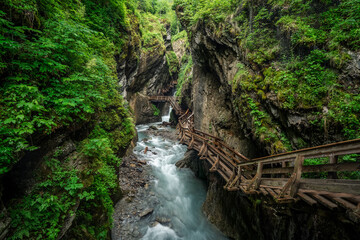 Wooden hike trail path inside a gorge with bue mountain river, Sigmund Thun Klamm, Kaprun, Austria