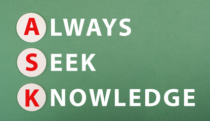 The words ask always seek knowledge are standing on a green colored paper, education concept, motivation