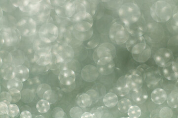 Bright bokeh. Blurred background with round bokeh. Bright bokeh in pattern. Bright ligts. Abstract blurred background. Green.