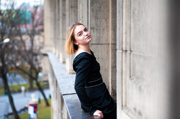 Young woman on the city balcony