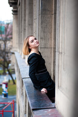 Young woman on the city balcony