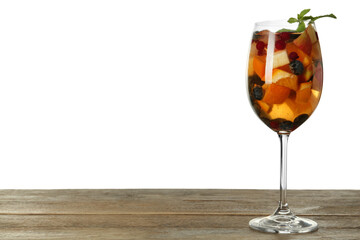 Glass of Red Sangria on wooden table against white background. Space for text