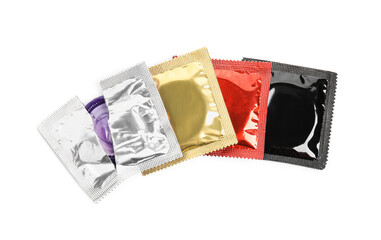 Obraz na płótnie Canvas Condom packages on white background, top view. Safe sex