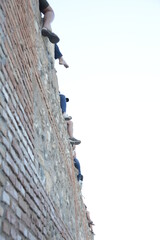 People sitting on a wall, view from low angle view