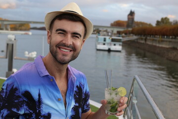 Man in luxury cruise drinking cocktail 