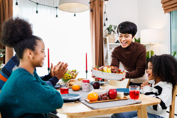 African American family. Merry Christmas. Happy family are having dinner at home. Celebration holiday and togetherness near Christmas tree.