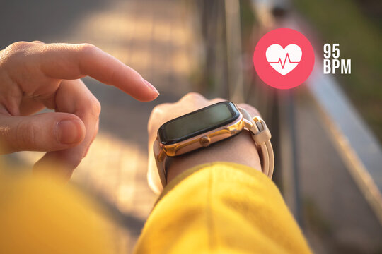 Smart watch with heart rate icon, healthcare concept. Woman check the pusle with application