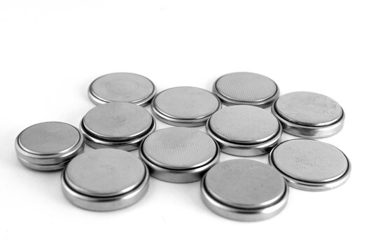 Used button batteries are placed with the Minus contact up. Big size batteries.