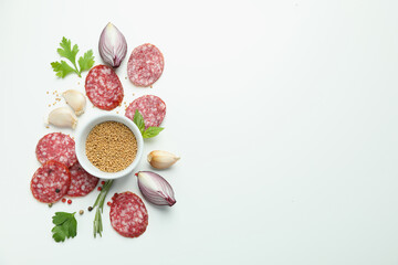Сoncept of tasty food with salami sausage on white background