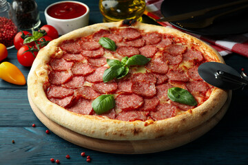 Concept of tasty food with Salami pizza on wooden table