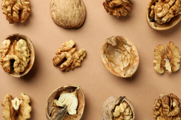 Flat lay composition with walnuts on brown background