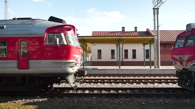 KAUNAS, LITHUANIA - Oct 02, 2021: The Kaunas train station with red trains on the railway in Lithuania