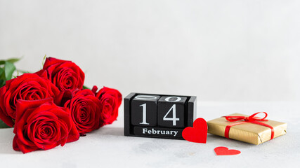 Valentine's day background with red roses bouquet, hearts, a gift box and calendar with the date 14 february on white background. Greeting card template for Valentine's Day. Side view, banner, sale