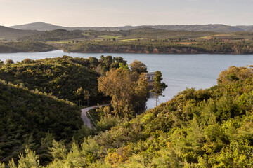 Fototapeta na wymiar A view of the reservoir lake Marathon (Greece) on a sunny, spring day
