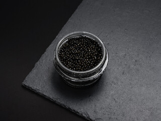 natural black sturgeon caviar in a glass jar - a delicacy of Russian cuisine