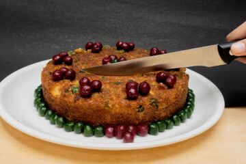 Cake Cutting with a Knife, Cake on a White Plate, On the Table, On the Wooden Table, Knife in Hand,