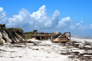 Fototapeta na wymiar Wooden walkway to the ocean beach background at Florida, USA.