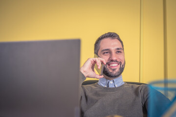 businessman smiling and speaking on the phone