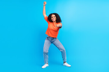 Full body photo of young african woman happy positive smile ride horse rodeo western isolated over blue color background