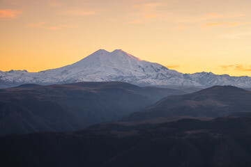 Autumn mountain landscape in the haze. Mount Elbrus in the background