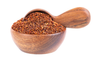 Rooibos red tea in wooden bowl and spoon, isolated on white background. Traditional herbal and organic tea.