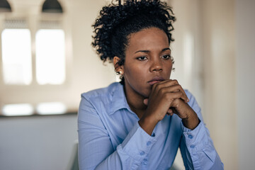 A focused adult African-American woman, thinking about her future, worried woman