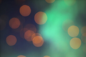 blurred shiny orange lights on green background