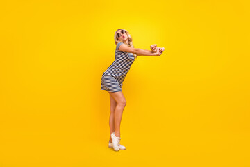 Fototapeta na wymiar Full length body size photo dancing woman wearing sunglass dress isolated vibrant yellow color background