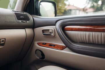 Classic suv car interior, with leather panels, wooden decoration and handle